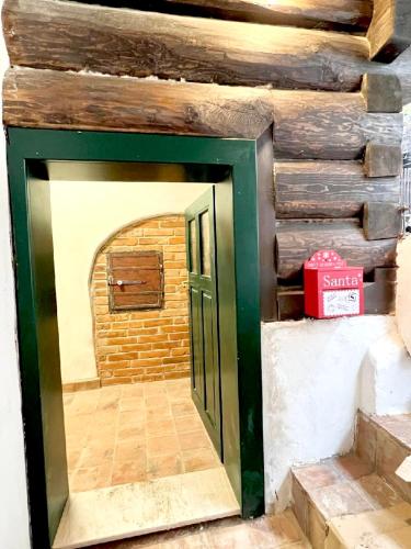 a door into a room with a brick wall at Santova roubenka in Štramberk