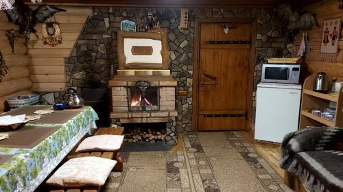a kitchen with a brick fireplace in a room at У Медовому Раю in Rostoka
