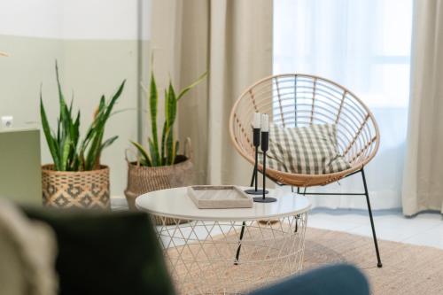 a rattan chair and a table in a living room at K-Houses A3 in Arta