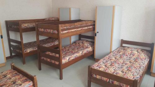 a group of bunk beds in a room at La Baleine Blanche - Hostel in Campan