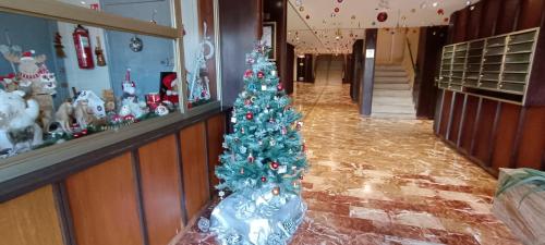 a christmas tree in the middle of a hallway at apartment 50m from historic town 5min Beach Palais Croisette - Free private parking in Cannes