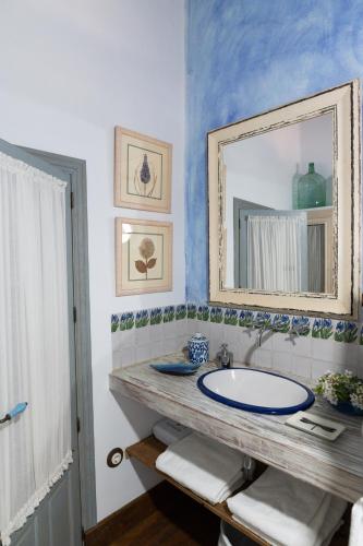a bathroom with a sink and a mirror at Cortijo Chacón in Cazalla de la Sierra