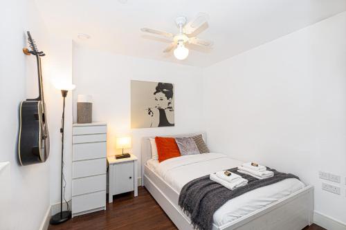 a bedroom with a bed and a ceiling fan at Bright & Cozy 1 BDR Apt wCharming Private Terrace in London