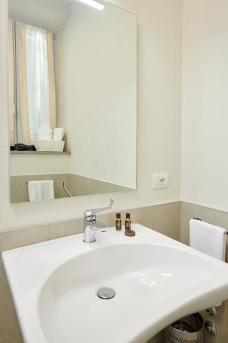 a bathroom with a white sink and a mirror at La Villa in Novara
