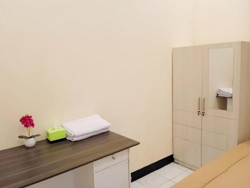 a room with a counter with a cabinet and a flower at Penginapan Prambanan TRISAN in Randugunting