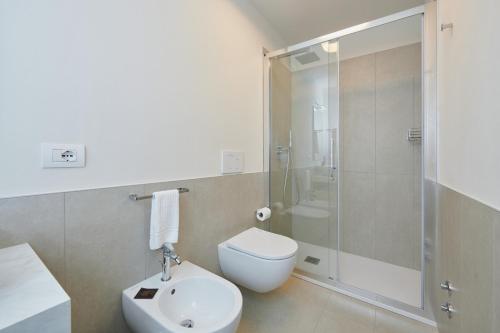 a bathroom with a shower and a toilet and a sink at La Villa in Novara