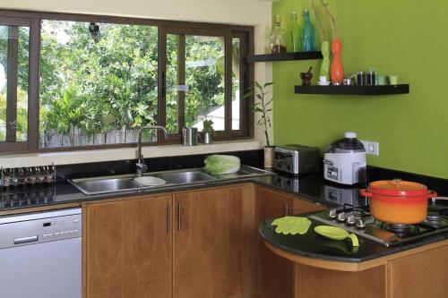 a kitchen with a sink and a counter top at Villa Fayette Sur Mer in Post of Flacq