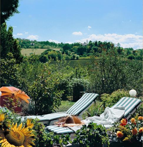 a picnic table and chairs in a field with sunflowers at B&B Il Giardino in Tavullia