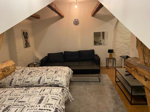 a living room with a bed and a couch at ATTIC FLOOR in Stockholm City! 918 in Stockholm