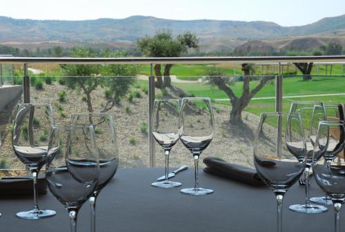 a group of wine glasses sitting on a table at Sercotel El Encin Golf in Alcalá de Henares