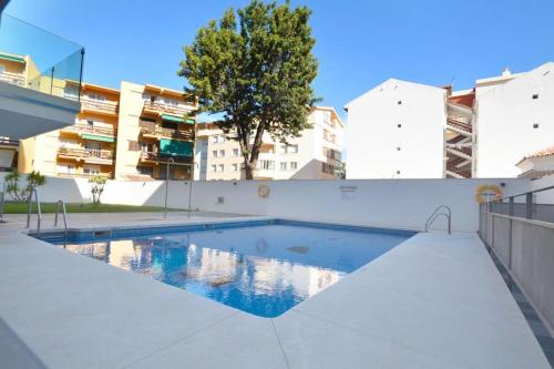 a swimming pool in front of a building at Superb Penthouse in Central Fuengirola in Fuengirola