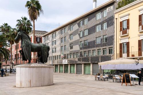 a horse statue in the middle of a city street at Donna Giacinta Blu Luxury Flat in Bari