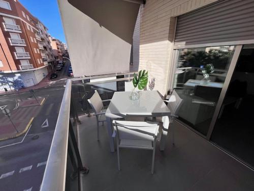a table and chairs on the balcony of a building at Modern and Stylish Apartament sea ​​views in Guardamar del Segura