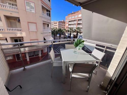 a balcony with a table and chairs on a balcony at Modern and Stylish Apartament sea ​​views in Guardamar del Segura