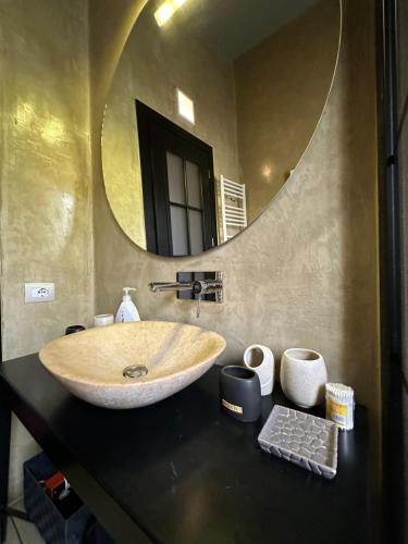 a bathroom with a sink and a mirror at Botanic Loft in Tirana