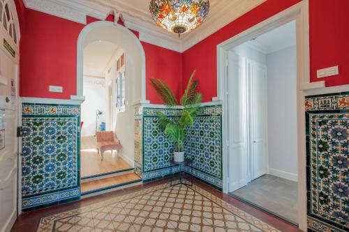 a room with red walls and a hallway with a potted plant at Casa Verde Ayamonte in Ayamonte