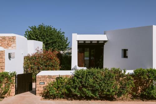 uma casa branca com uma porta preta em Casa Maca em Ibiza