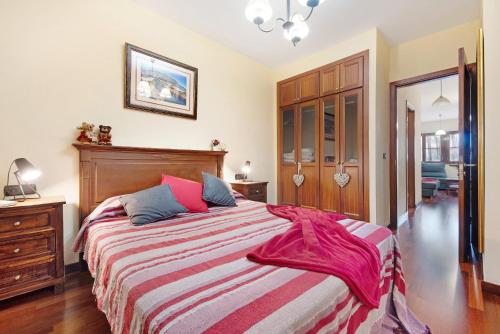 a bedroom with a large bed with a striped blanket at Salsalitre Chico in Garachico