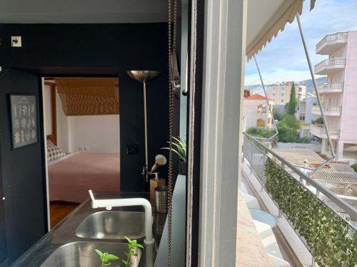 a balcony with a sink and a bedroom at Perfect location for the Olympic stadium Would sleep 4 comfortably for an overnight stay in Athens