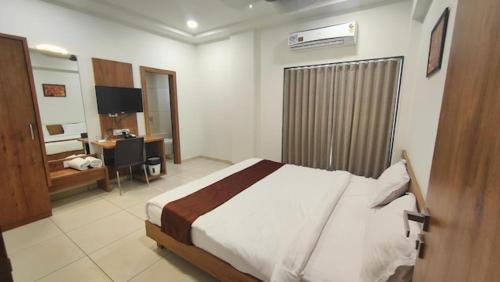 a bedroom with a bed and a desk in it at Mj birla international in Hyderabad