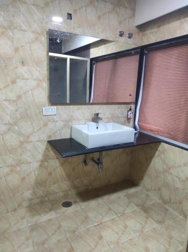 a bathroom with a sink and a mirror at Mj birla international in Hyderabad