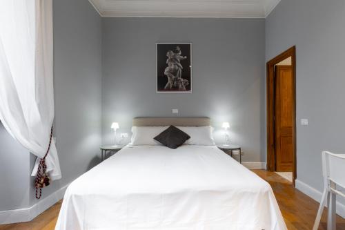 a bedroom with a white bed and two tables at River61 - Guest House in Rome