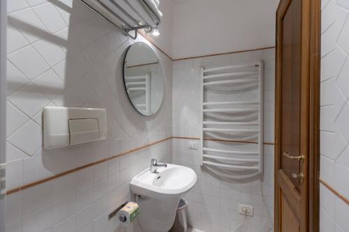 a small bathroom with a sink and a mirror at River61 - Guest House in Rome