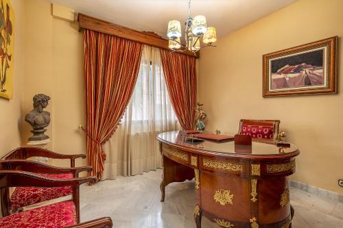 a home office with a desk and a window at Casa de Amigos La Latina con piscina, chimenea y barbacoa in Illora