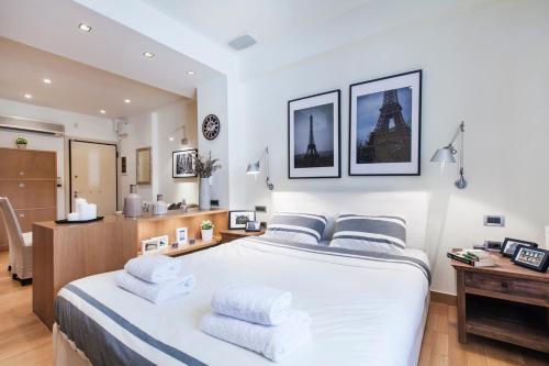 a bedroom with a large white bed with two pillows at Hilton Area 1BR Executive Flat in Athens
