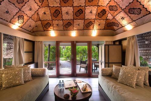 a living room with a couch and a table at Castaway Island, Fiji in Castaway Island