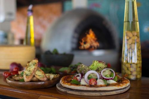 two pizzas sitting on top of a table with an oven at Castaway Island, Fiji in Castaway Island