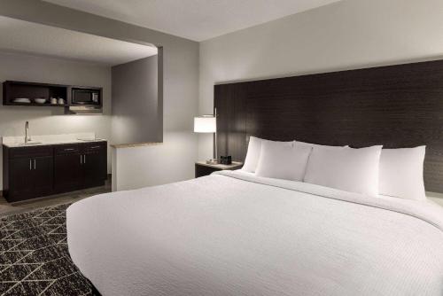 a large white bed in a hotel room at La Quinta Inn & Suites by Wyndham Lake George in Lake George