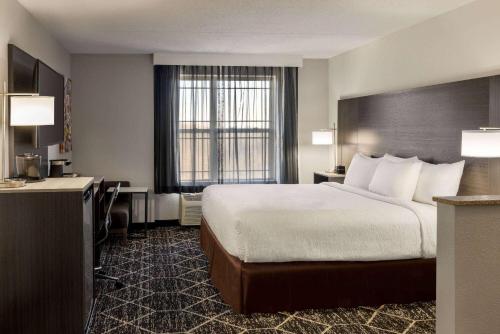 a hotel room with a bed and a desk at La Quinta Inn & Suites by Wyndham Lake George in Lake George