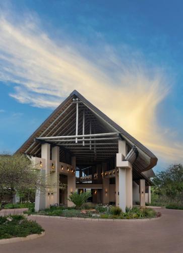 a large building with a sky in the background at Radisson Safari Hotel Hoedspruit in Hoedspruit