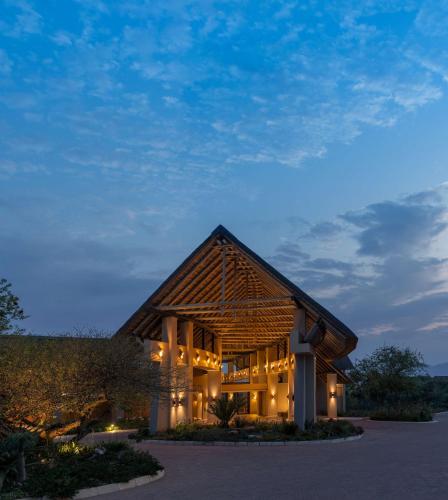a large building with lights on it at night at Radisson Safari Hotel Hoedspruit in Hoedspruit