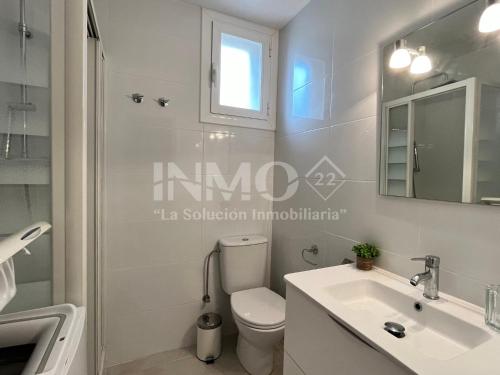 a white bathroom with a toilet and a sink at Moderno apartamento a pocos metros de la playa 126A - INMO22 in Cambrils