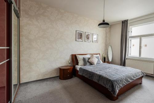 a bedroom with a bed and a window at Nice big apartment 2bds - Belgicka in Prague