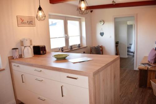 a kitchen with a wooden counter top in a room at Haus Hanna in Dagebüll