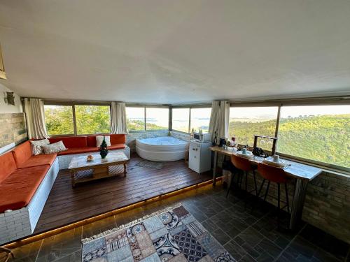 a large bathroom with a tub and a large window at Panoramic View in ‘Isfiyā