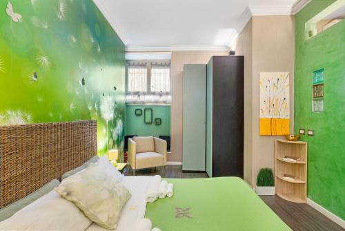 a bedroom with a bed and a green wall at GREEN butterfly house holiday in Rome