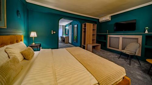 a bedroom with a large bed and a tv at Hotel Cocó in Timişoara