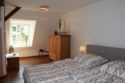 a bedroom with a bed and a window at Ole Hof in Risum-Lindholm