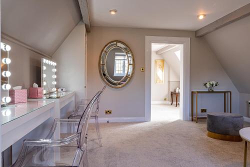 a dining room with a mirror and a table at Holbrook Manor & Spa in Wincanton