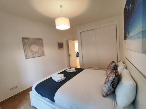 a bedroom with a bed with two towels on it at Albufeira Valley 2 With Pool by Homing in Albufeira