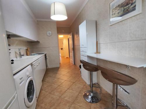 a kitchen with a sink and a washing machine at Albufeira Valley 2 With Pool by Homing in Albufeira
