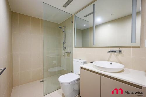 a bathroom with a toilet and a sink and a shower at MetaWise Sydney CBD Haymarket Luxe 2Bed Penthouse Aqua in Sydney