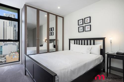 a bedroom with a large bed and a large window at MetaWise Sydney CBD Haymarket Luxe 2Bed Penthouse Aqua in Sydney
