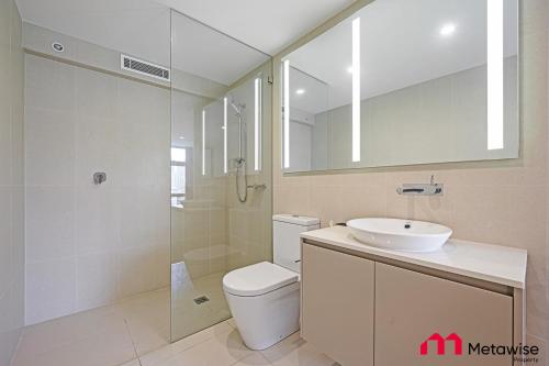 a bathroom with a toilet and a sink and a shower at MetaWise Sydney CBD Haymarket Luxe 2Bed Penthouse Aqua in Sydney