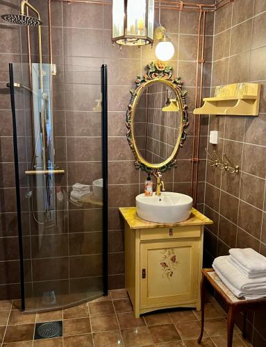 a bathroom with a sink and a mirror and a shower at Villa Billerud in Säffle