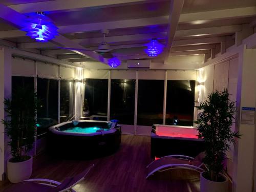 a room with a jacuzzi tub and purple lights at Agriturismo Fonte Rosa in Fiastra